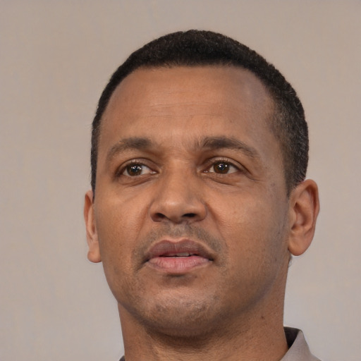 Neutral black adult male with short  black hair and brown eyes