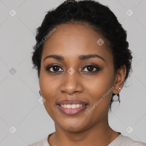 Joyful black young-adult female with short  black hair and brown eyes