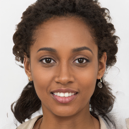 Joyful black young-adult female with medium  brown hair and brown eyes