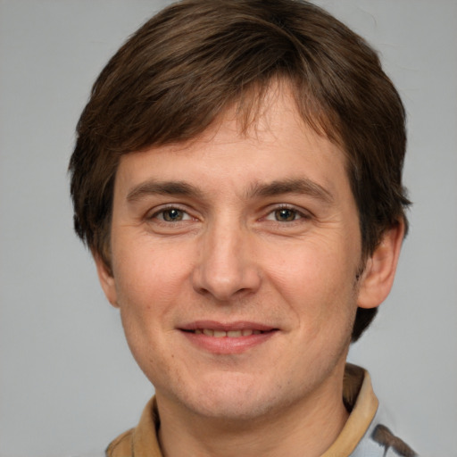 Joyful white adult male with short  brown hair and grey eyes