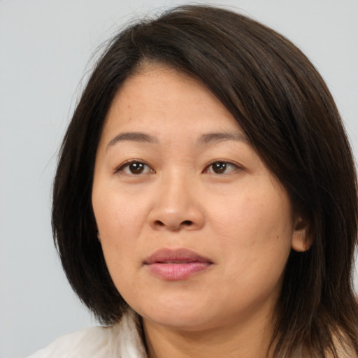 Joyful white adult female with medium  brown hair and brown eyes