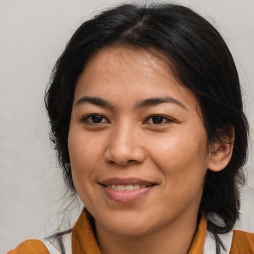 Joyful asian young-adult female with medium  brown hair and brown eyes