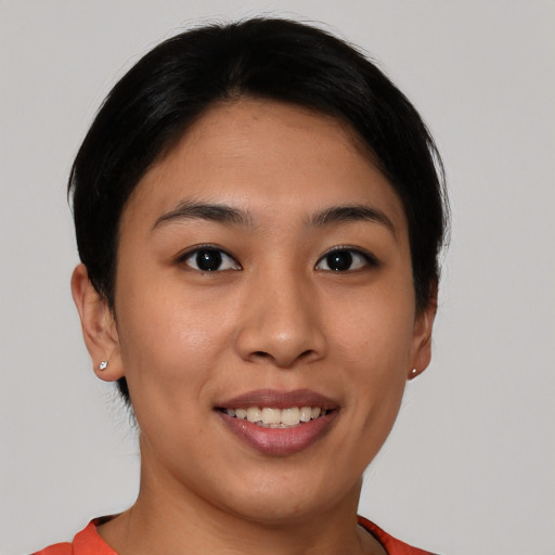 Joyful asian young-adult female with short  brown hair and brown eyes