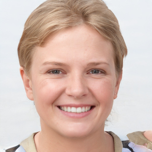 Joyful white young-adult female with short  brown hair and grey eyes