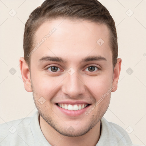 Joyful white young-adult male with short  brown hair and grey eyes