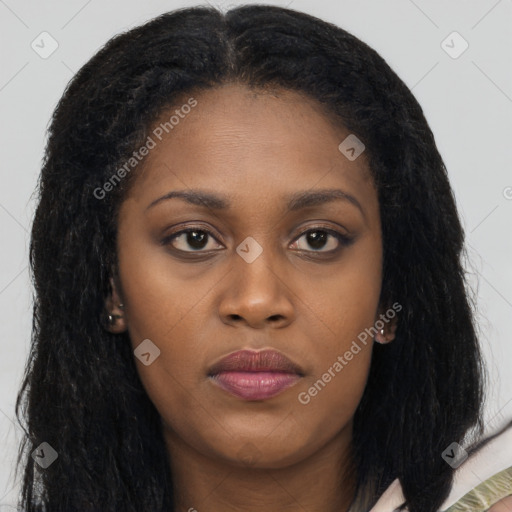 Joyful black young-adult female with long  brown hair and brown eyes