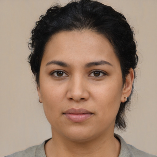 Joyful latino young-adult female with short  brown hair and brown eyes