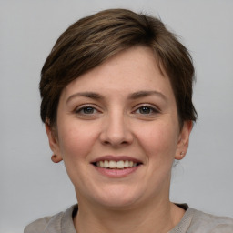 Joyful white young-adult female with short  brown hair and grey eyes