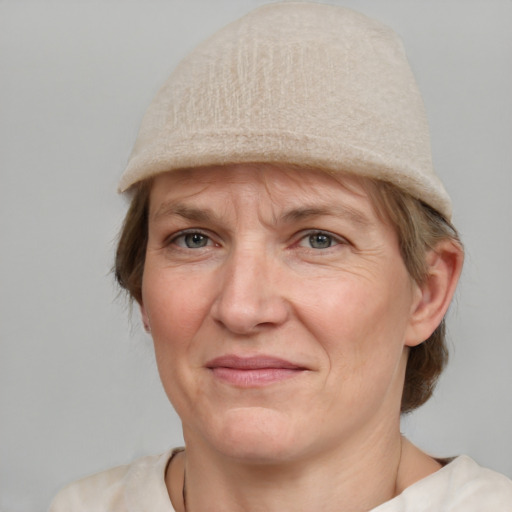 Joyful white adult female with medium  brown hair and grey eyes