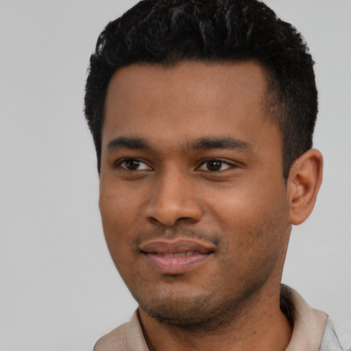 Joyful black young-adult male with short  black hair and brown eyes