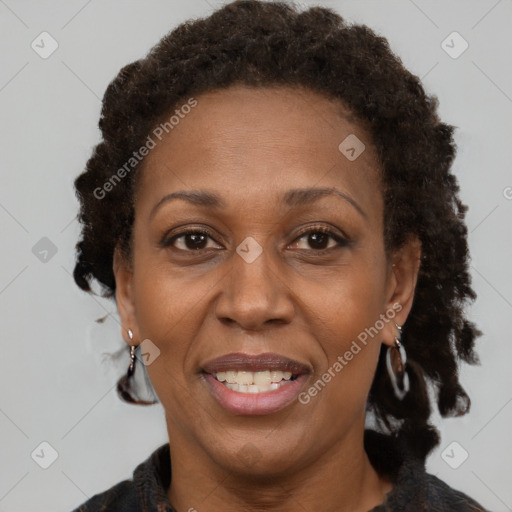 Joyful black adult female with short  brown hair and brown eyes