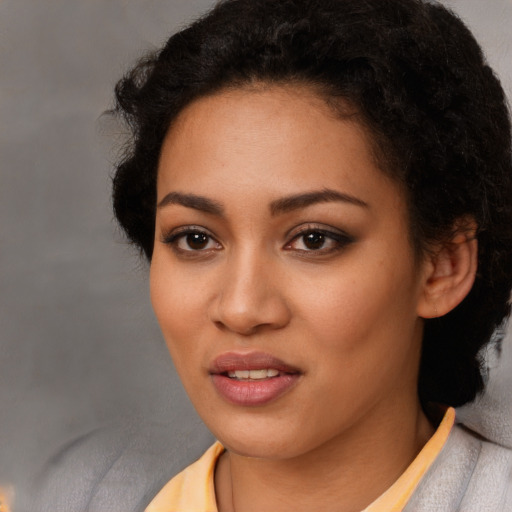 Joyful latino young-adult female with short  black hair and brown eyes