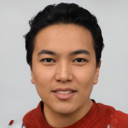 Joyful asian young-adult male with short  black hair and brown eyes