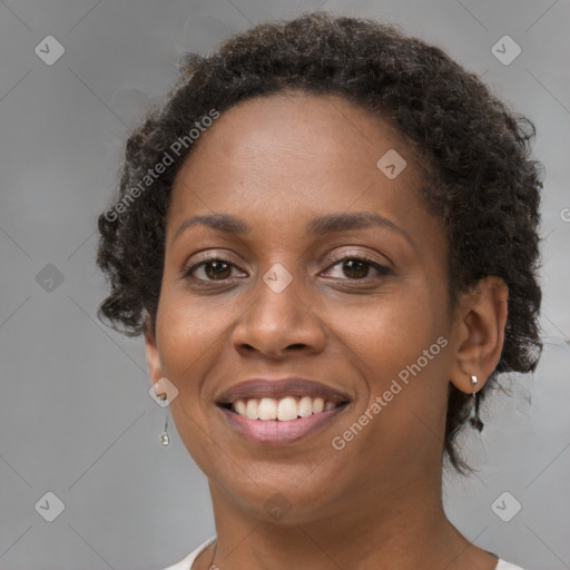 Joyful black young-adult female with short  brown hair and brown eyes