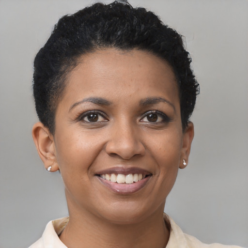 Joyful black young-adult female with short  brown hair and brown eyes