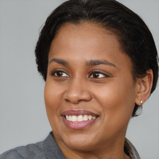 Joyful black young-adult female with medium  brown hair and brown eyes