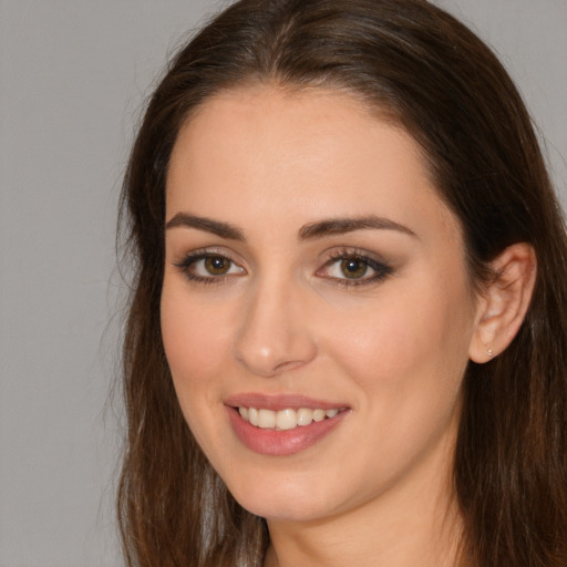 Joyful white young-adult female with long  brown hair and brown eyes