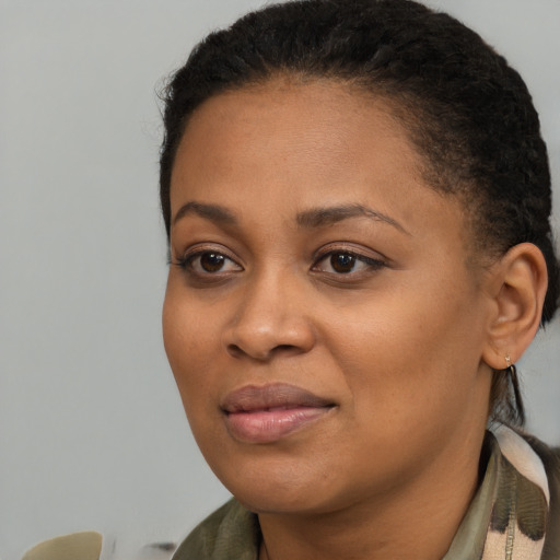 Joyful black young-adult female with medium  brown hair and brown eyes