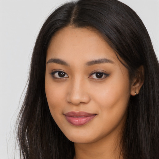 Joyful asian young-adult female with long  brown hair and brown eyes