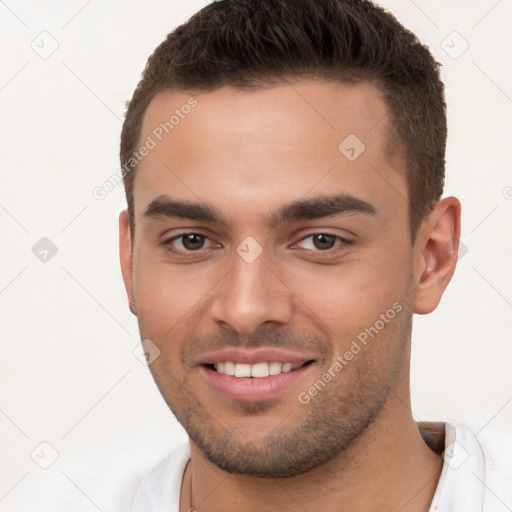 Joyful white young-adult male with short  brown hair and brown eyes