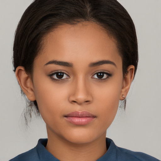 Joyful latino young-adult female with medium  brown hair and brown eyes