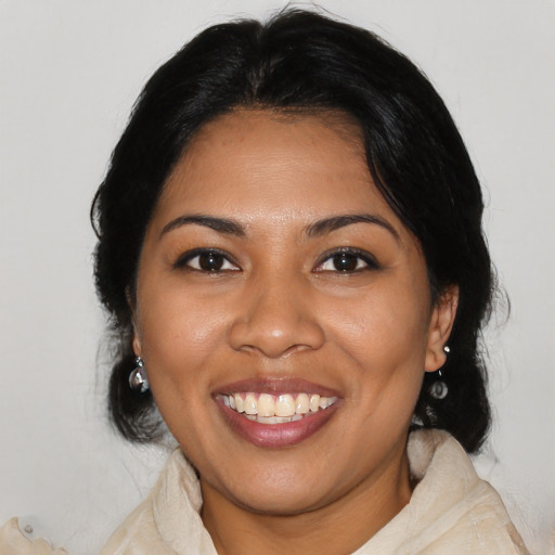Joyful latino young-adult female with medium  black hair and brown eyes