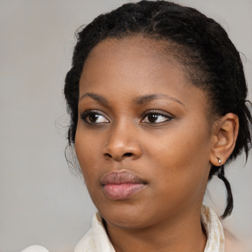 Neutral black young-adult female with medium  brown hair and brown eyes