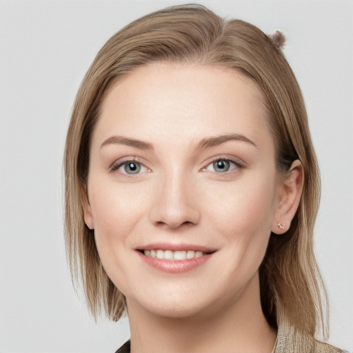 Joyful white young-adult female with medium  brown hair and blue eyes