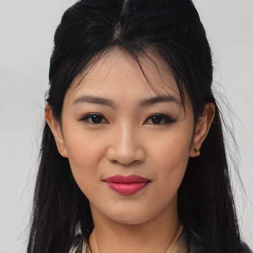 Joyful asian young-adult female with long  brown hair and brown eyes