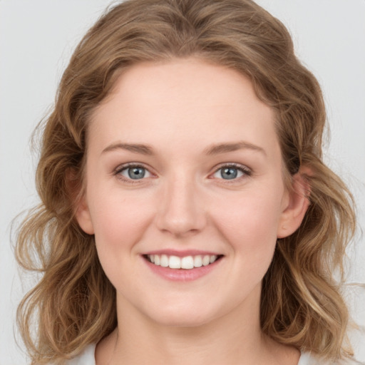 Joyful white young-adult female with medium  brown hair and green eyes