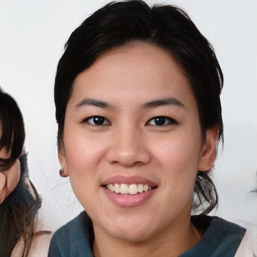 Joyful white young-adult female with medium  black hair and brown eyes