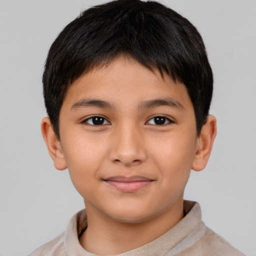 Joyful asian child male with short  brown hair and brown eyes