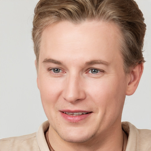 Joyful white adult male with short  brown hair and grey eyes