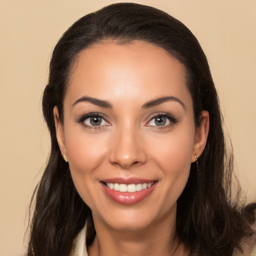 Joyful white young-adult female with long  brown hair and brown eyes