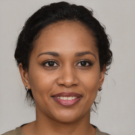 Joyful black young-adult female with short  brown hair and brown eyes