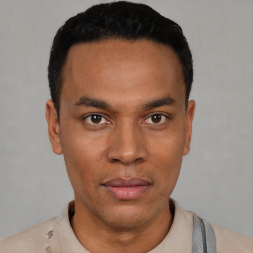 Joyful latino young-adult male with short  black hair and brown eyes