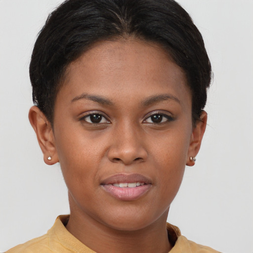 Joyful black young-adult female with short  brown hair and brown eyes