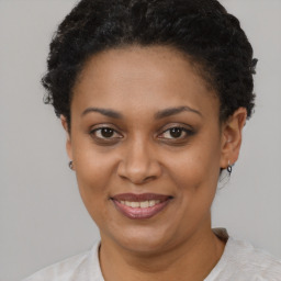 Joyful black young-adult female with short  brown hair and brown eyes