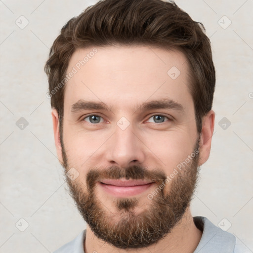 Joyful white young-adult male with short  brown hair and grey eyes