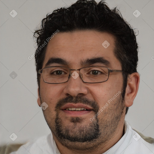 Joyful white adult male with short  black hair and brown eyes