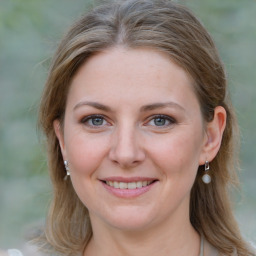 Joyful white young-adult female with medium  brown hair and blue eyes