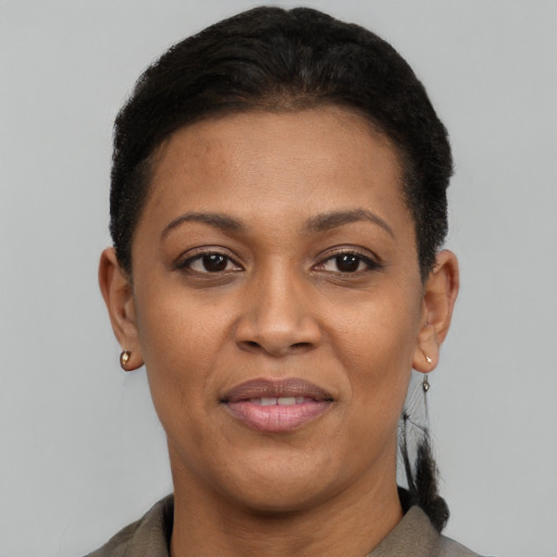 Joyful black adult female with short  black hair and brown eyes