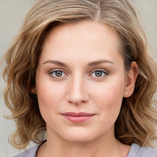 Joyful white young-adult female with medium  brown hair and blue eyes