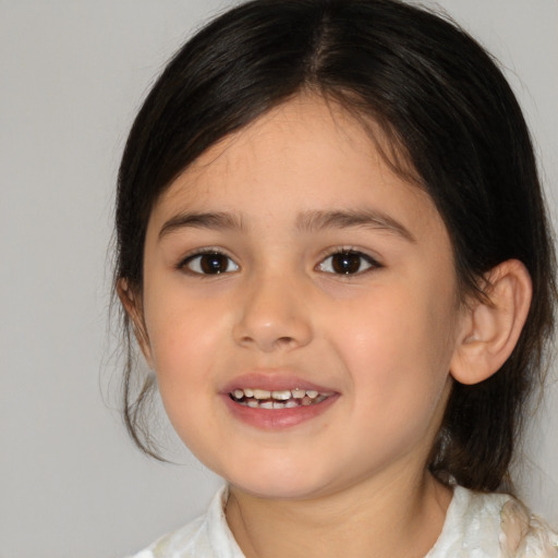 Joyful white child female with medium  brown hair and brown eyes