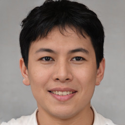 Joyful asian young-adult male with short  brown hair and brown eyes