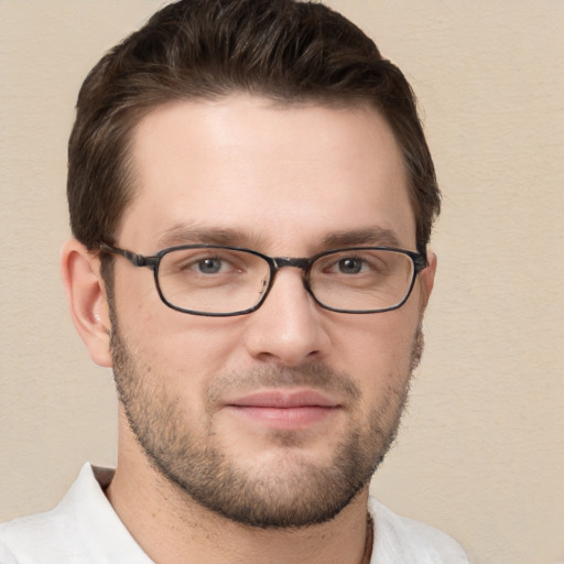 Joyful white young-adult male with short  brown hair and grey eyes