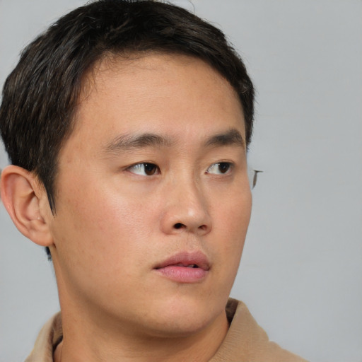 Neutral asian young-adult male with short  brown hair and brown eyes