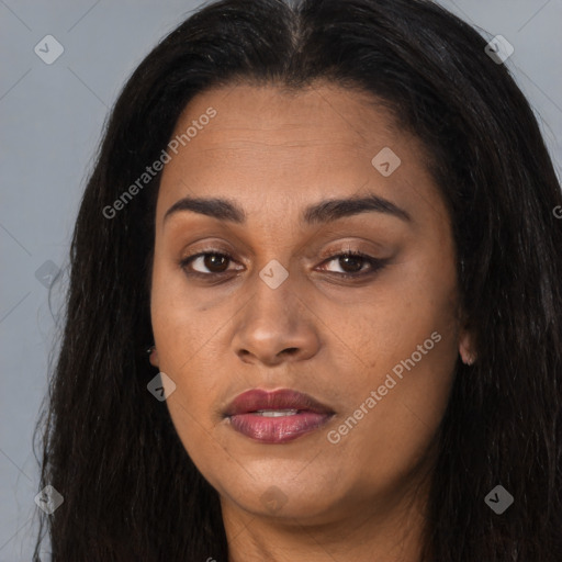 Joyful black young-adult female with long  brown hair and brown eyes