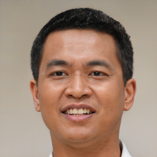 Joyful asian young-adult male with short  brown hair and brown eyes
