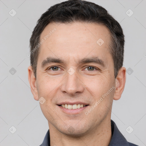 Joyful white adult male with short  brown hair and brown eyes